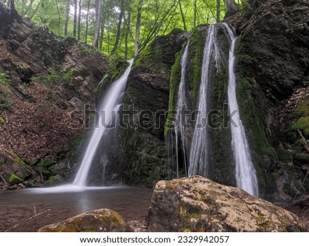waterfall at the spring misty forest