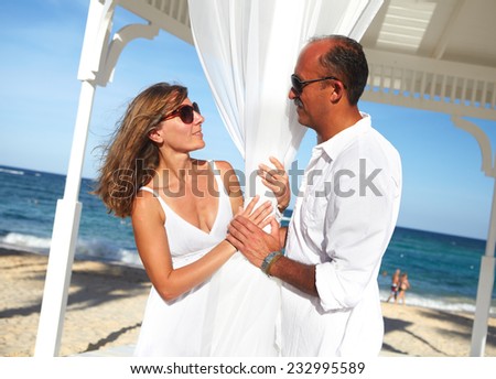Loving romantic couple relaxing on the beach.