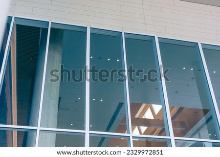 facade large windows of modern business office building in metropolitan. hall shopping mall glass window design Royalty-Free Stock Photo #2329972851