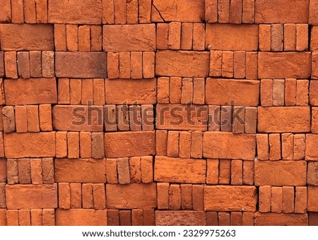 Closeup photo of Stack of red bricks at construction sites, ready to use for construction materials. Red bricks for building a house. For background, 3d rendering, or architecture
