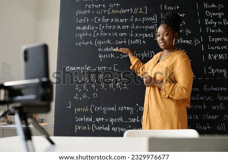 Teacher explaining IT material online Royalty-Free Stock Photo #2329976677