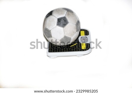 football, the ball is on the scales to measure the weight