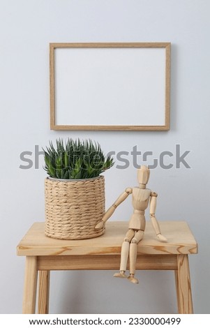 Photo frame on the wall near the table with decor