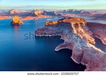 Lake Powell is a reservoir on the Colorado River located in the U.S. states of Utah and Arizona. Small islands stick out of the water.  Landscape under the wing of an airplane