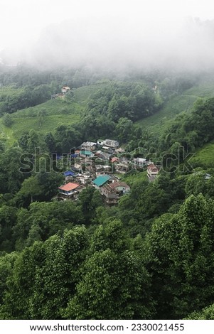 scenic mountain landscape, lush green valley and rain bearing monsoon clouds over the sky. beautiful panoramic view of himalaya foothills and countryside near darjeeling hill station, in india Royalty-Free Stock Photo #2330021455