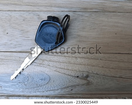 Motorcycle Key on A Brown wooden Table