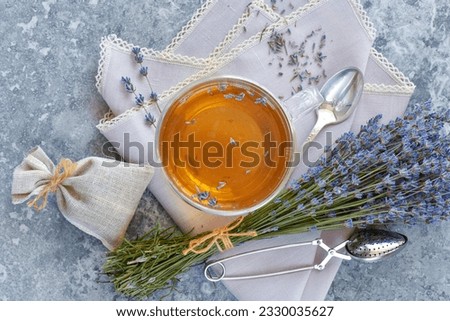 Bunch of lavender flowers, sachet filled with dried lavender and healthy tea. Top view. Flat lay.