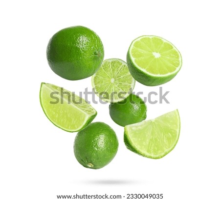 Fresh lime fruits falling on white background Royalty-Free Stock Photo #2330049035