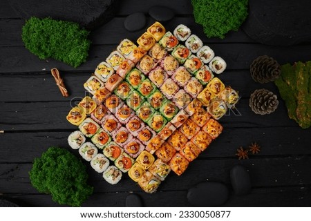 Above view of various sushi and rolls placed on stone board. Japanese food fest. Top view, flat lay