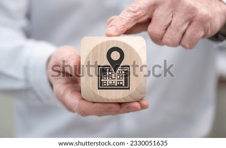 Hand holding a wooden cube with symbol of gps concept
