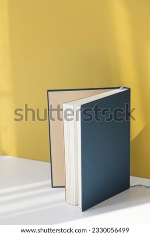 Blue book or note on yellow background