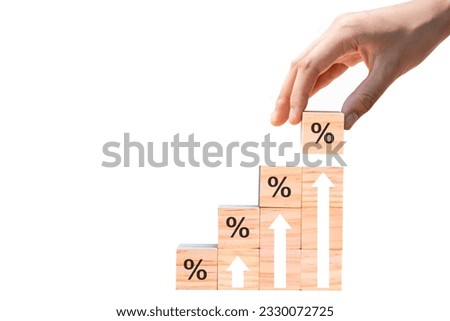 wooden block with percentage sign and arrow pointing up. isolated on white background. Concepts of returns from stocks, mutual funds, interest rates and dividends.