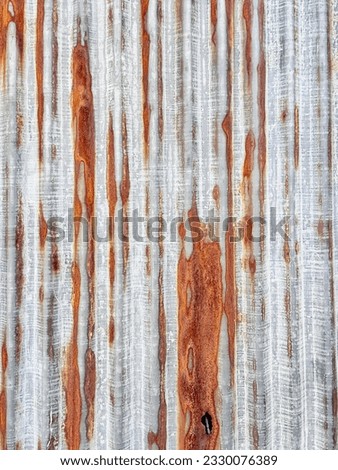 barn door with rust and peeling paint on it.