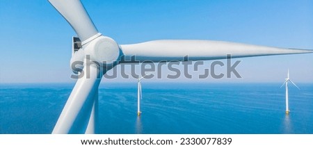Windmill Park with a blue sky close up of windmill turbines at sea Royalty-Free Stock Photo #2330077839