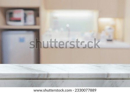 white marble stone counter top with blurred kitchen background