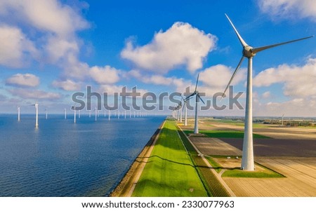 Windmill turbines at sea generate green energy in the Netherlands. Drone view at windmill park Royalty-Free Stock Photo #2330077963