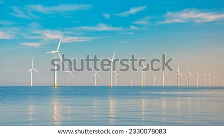 Windmill turbines Park with a blue sky, windmill turbines park in the ocean. Netherlands Europe the biggest wind park in the Netherlands Royalty-Free Stock Photo #2330078083