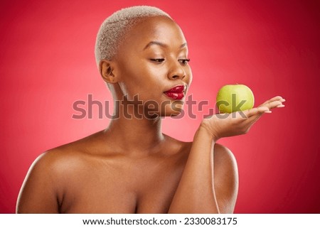 Black woman, apple and thinking for natural nutrition or healthy diet against a red studio background. African female person palm with natural organic green fruit for food snack, health and wellness