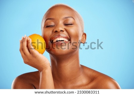 Orange, funny and black woman with skincare, dermatology or cosmetics on a blue studio background. Female person, humor or model with citrus fruit, health or wellness with vitamin c or natural beauty