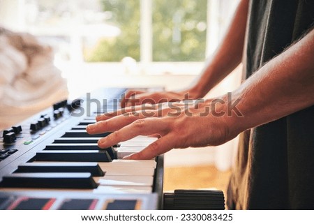 Piano, man and hands on keys for music, creative talent and skills in home studio. Closeup, musician and playing synthesizer keyboard for audio performance, sound artist and learning instrument notes Royalty-Free Stock Photo #2330083425