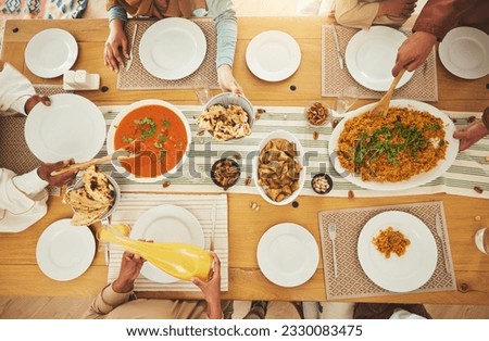 Food, Eid Mubarak and above of family eating at table for Islamic celebration, festival and lunch together. Ramadan, religion and hands with meal, dish and cuisine for fasting, holiday and culture