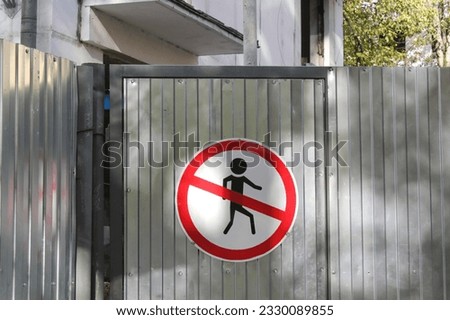 Prohibited symbol No entry Not allowed. Forbidden round warning sign. Safety notice on closed metal door fence. Construction site danger access for people. Private area alert icon, security zone
