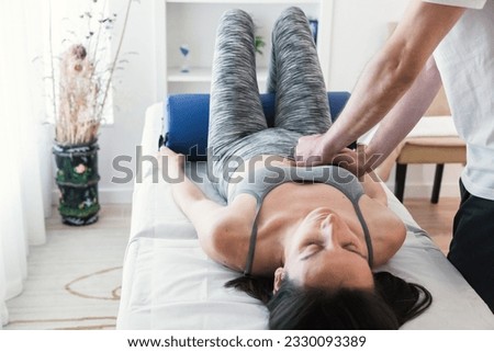 Therapist doing a session with localized massage in the abdominal region, belly to improve the health condition of the patient in terms of the internal organs of the abdomen. Royalty-Free Stock Photo #2330093389
