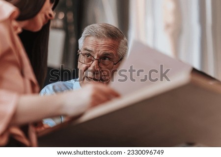 Mature company boss telling tips and tricks to a business client for better efficiency, growing business