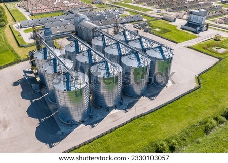aerial panoramic view on agro-industrial complex with silos and grain drying line for drying cleaning and storage of cereal crops Royalty-Free Stock Photo #2330103057