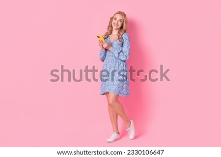 Full size portrait of lovely cheerful girl hold use smart phone blogging chatting isolated on pink color background