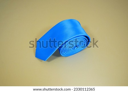 plain pattern blue tie rolled isolated on plain background nobody 