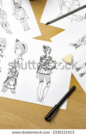 An artist draws characters for computer games. Illustrator drawing sketches on paper. Animation design studio. Animator designer. 