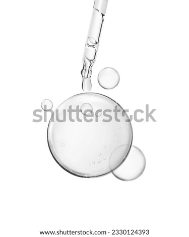 soft water bubble or cosmetic liquid serum drops with laboratory glass pipette on white background. Beauty and skincare Royalty-Free Stock Photo #2330124393