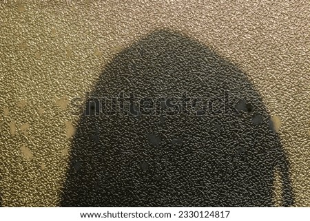 A close-up photo of an abstract shadow on a wall with uneven textures, a close-up shot in the morning looks bright and aesthetic