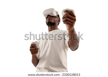 african american man in white t-shirt in virtual reality glasses holds joysticks on white isolated background, the guy uses vr glasses