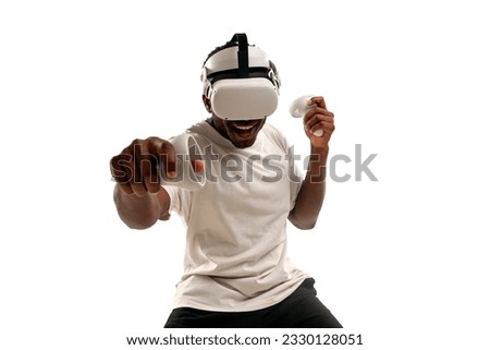 african american male boxer plays and fights in virtual reality glasses on white isolated background, the guy uses modern vr gadget and plays virtual boxing