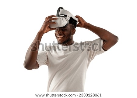 african american man in white t-shirt puts on virtual reality glasses and smiles on white isolated background, the guy uses a modern vr gadget
