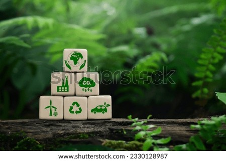 Wooden cubes with clean energy icon standing on eco friendly icon.  Green business and sustainable development. World earth day. Save of earth, saving environment, net zero emissions concept. Royalty-Free Stock Photo #2330128987