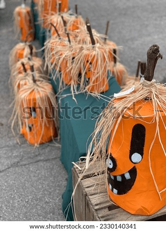 In a playful Halloween scene, a cheerful smiley face graces the surface of a vibrant pumpkin, adding a delightful touch of whimsy and inviting festive joy