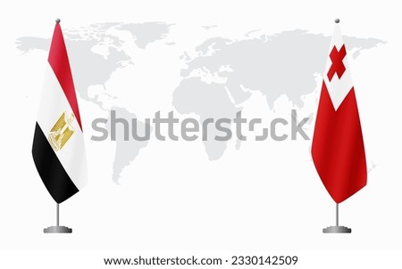 Egypt and Tonga flags for official meeting against background of world map.