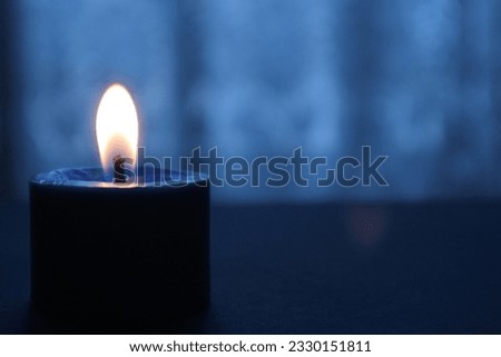 A Candle Flame In The Dark Royalty-Free Stock Photo #2330151811