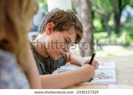 Preteen School Boy Drawing with Felt Pens. Back to School. Caucasian Little Schoolboy Drawing Picture at Home. Hobby, Education Concept.