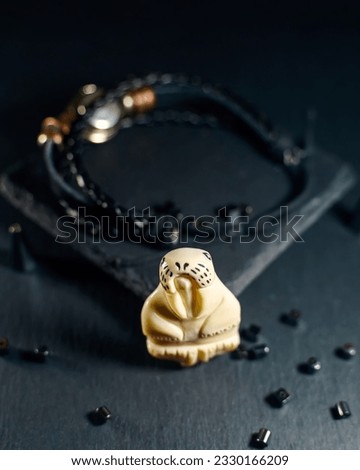 Amulet in the shape of a walrus figurine made of walrus tusks
