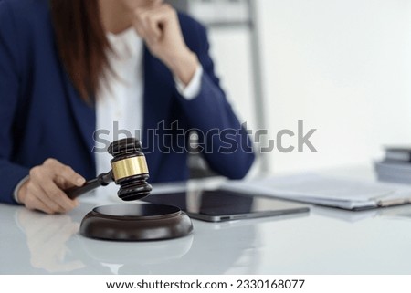 Lawyer preparing to sign a contract and wooden gavel on table justice and law concept