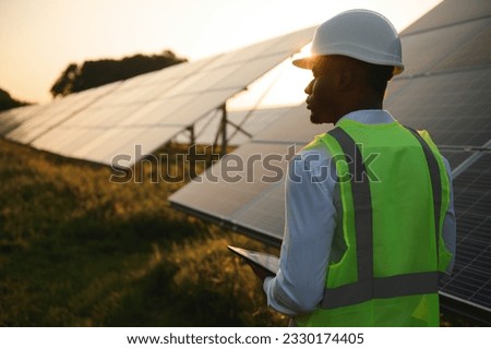 African american technician check the maintenance of the solar panels. Black man engineer at solar station Royalty-Free Stock Photo #2330174405