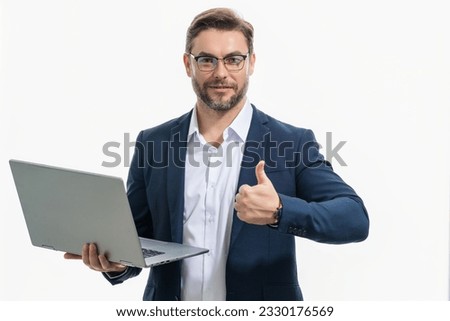 Hispanic man working on laptop in studio. Business man in suit checking email on laptop, writing message in social network, using internet, searching information on laptops. Business man using laptop.