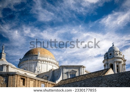 Roof of the cathedral of Cadiz, Andalusia, Spain, with the tower and golden dome as protagonists and blue sky