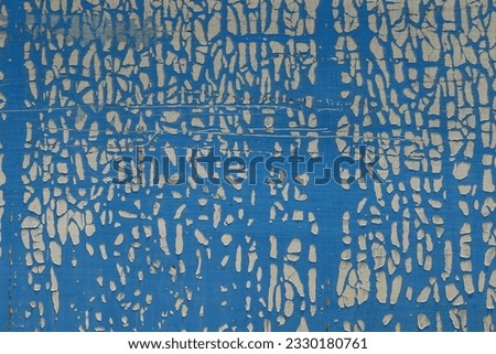 Cracked and weathered plastic wrap on metal surface. Abstract shapes grungy background. Royalty-Free Stock Photo #2330180761