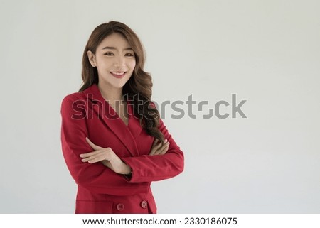 Pretty lovely manager lady successful business Asian woman in a red suit isolated over the background. arms crossed, smiling, and looking camera.