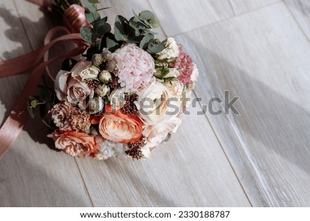 Bouquet of roses on a gray background with a wooden texture with copyspace. Background for congratulations on Women's Day, International Women's Day, wedding invitations.